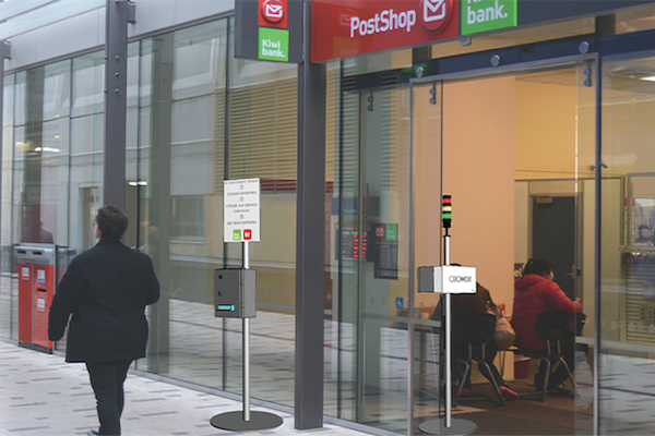 Man-walking-past-store-with-rfid-tag-dispensers