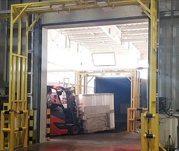 The image depicts a busy industrial scene within a warehouse, where a red forkl