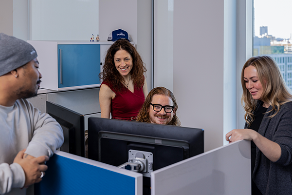 employees-sitting-around-a-table-at-a-meeting