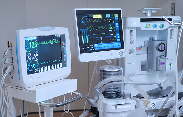 Advanced medical monitors and ventilator in a healthcare setting, illustrating Impinj's commitment to technology in user experience.
