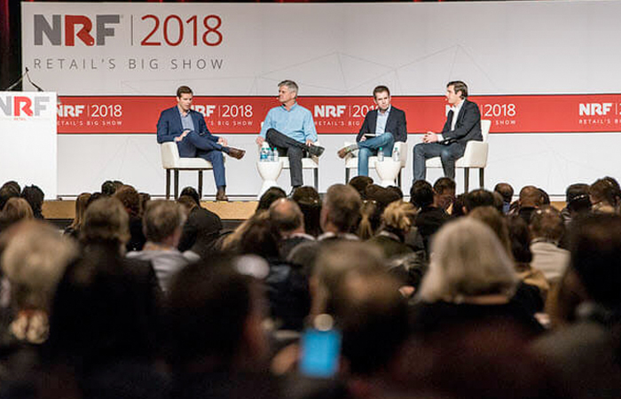 Panelists discussing at NRF 2018 Retail's Big Show in a crowded auditorium