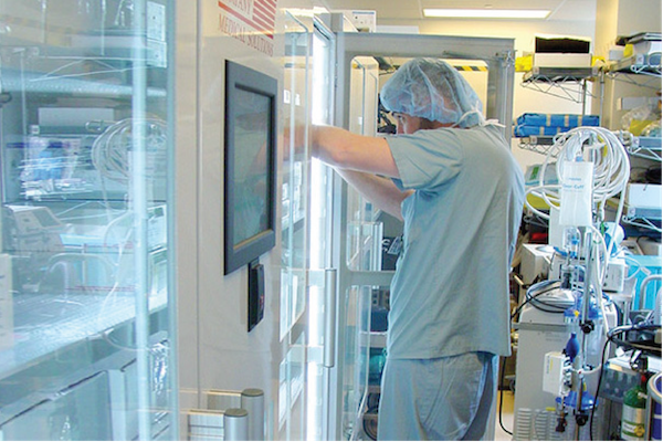 doctor-in-scrubs-reaching-in-cabinet