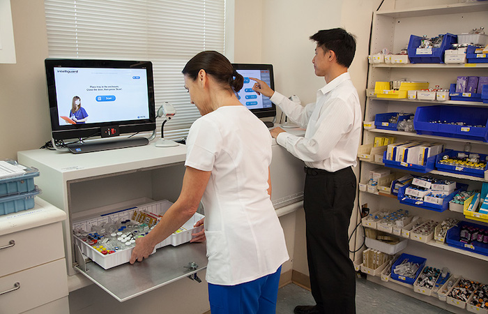 Two healthcare professionals are engaged in a task at a medical facility, with one person