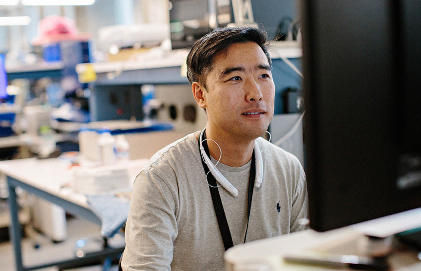 A professional setting captures a focused employee at their workstation, engrossed in their