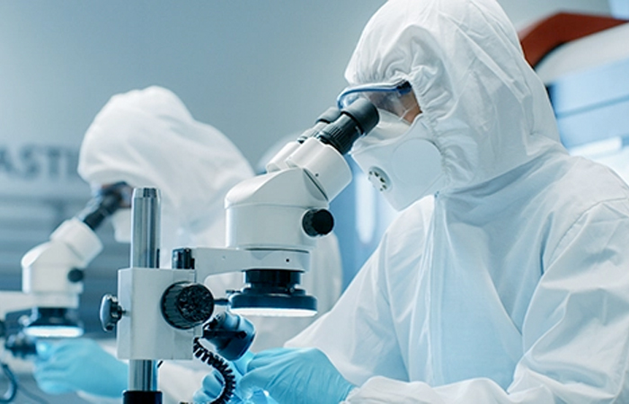 In the sterile environment of a high-tech laboratory, two scientists clad in protective suits