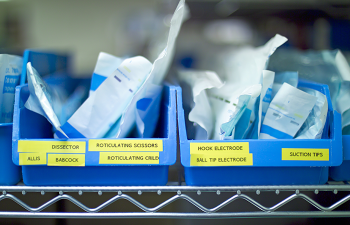 This image showcases a variety of medical tools neatly organized in blue storage bins, each