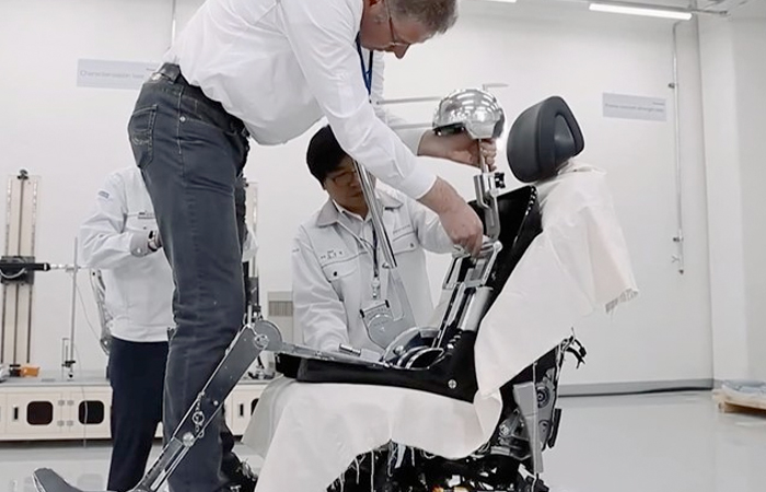 In a high-tech laboratory setting, two professionals in white lab coats are engaged in