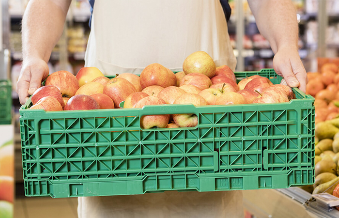 In the bustling aisles of a grocery store, a customer's hands are shown