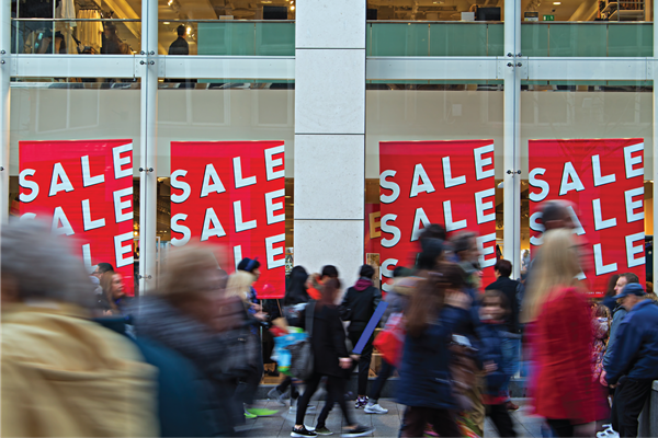 Photo-of-people-outside-store-front-with-sale-signs