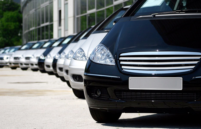 A lineup of sleek black and silver cars parked in a diagonal row, showcasing their