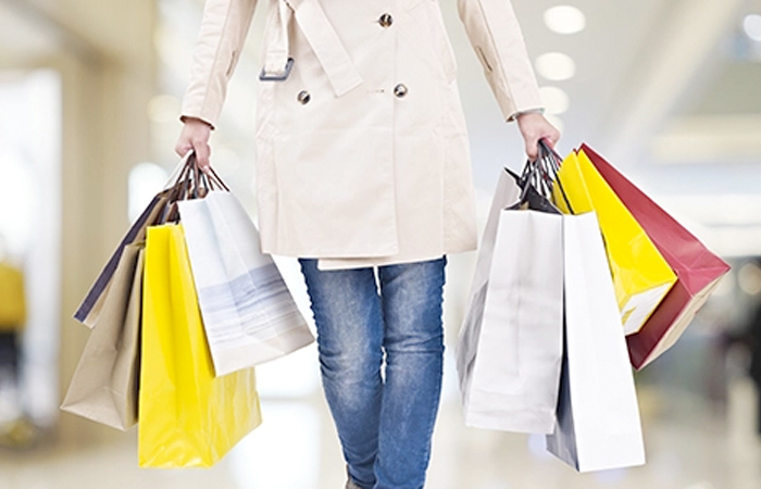 Shopper with multiple bags in a mall illustrating the future of retail with Impinj RAIN RFID technology