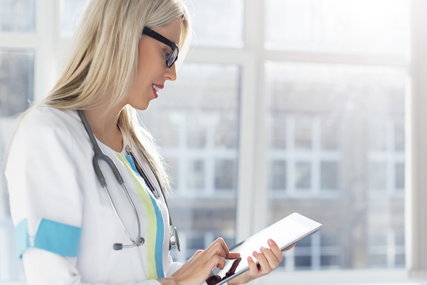 photo-of-woman-doctor-on-tablet