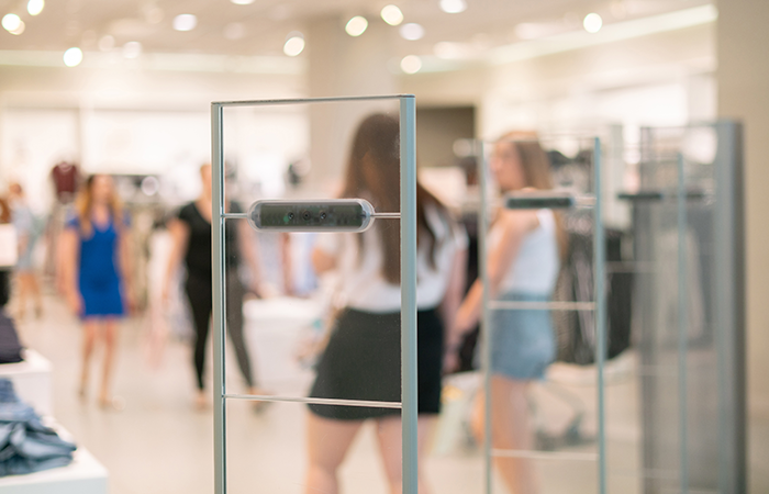 A sleek glass door with a modern black handle stands ajar, offering a glimpse