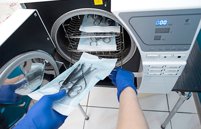 In the sterile environment of a medical facility, a professional in blue gloves carefully places