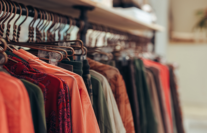 This image showcases a variety of colorful clothing items neatly arranged on hangers, displayed