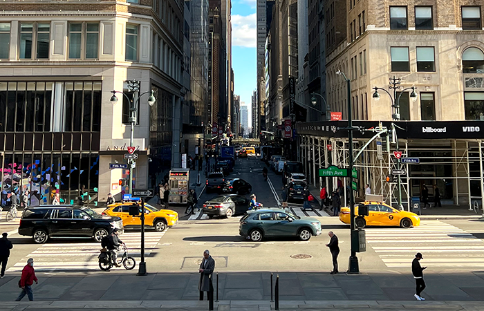 This bustling city scene captures the essence of urban life with a view down a busy