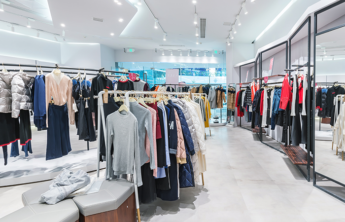 Bright and modern retail store interior with neatly organized clothing displays, reflecting Impinj's focus on enhancing user experience