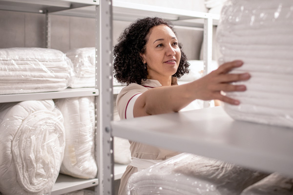 woman-shelving-white-linens