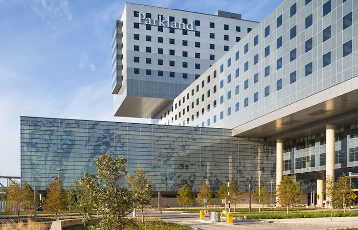The image showcases the modern architecture of the Parkland hospital, a state-of-the