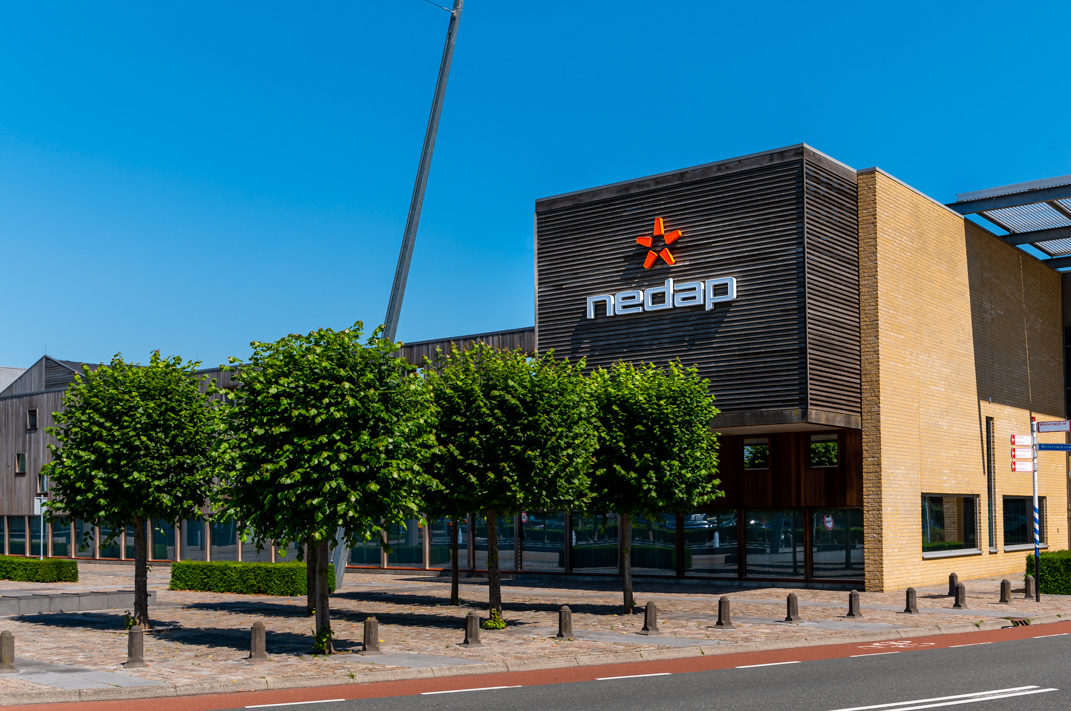 The modern facade of the Nedap building is captured on a bright sunny day,