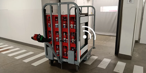 Metal cart carrying Impinj RFID products in an industrial indoor setting reflecting the company's focus on innovative inventory solutions and user experience enhancement.