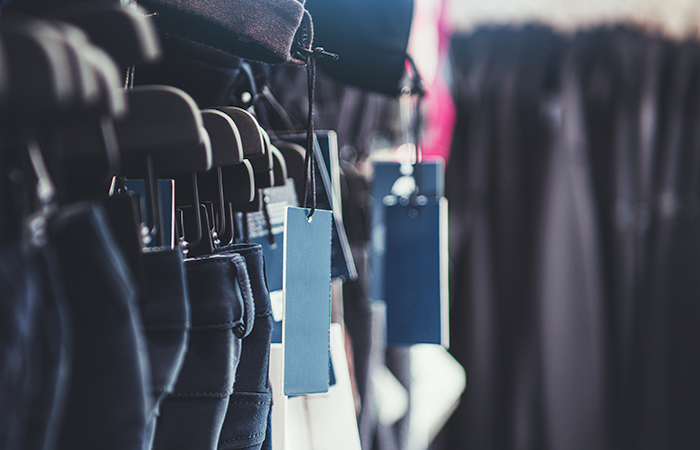 This image showcases a selection of clothing items on hangers, each with a blue