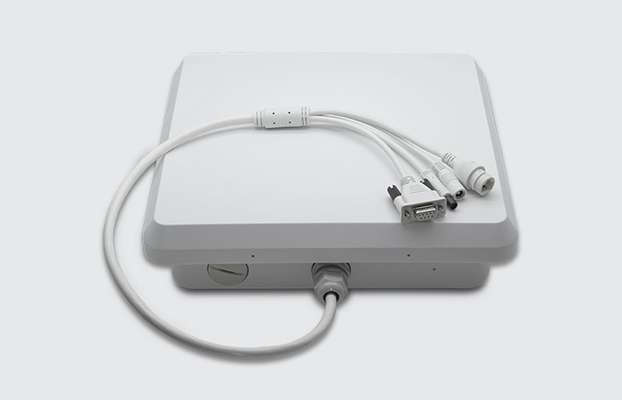 The image displays a modern Impinj RFID reader with a sleek, white design