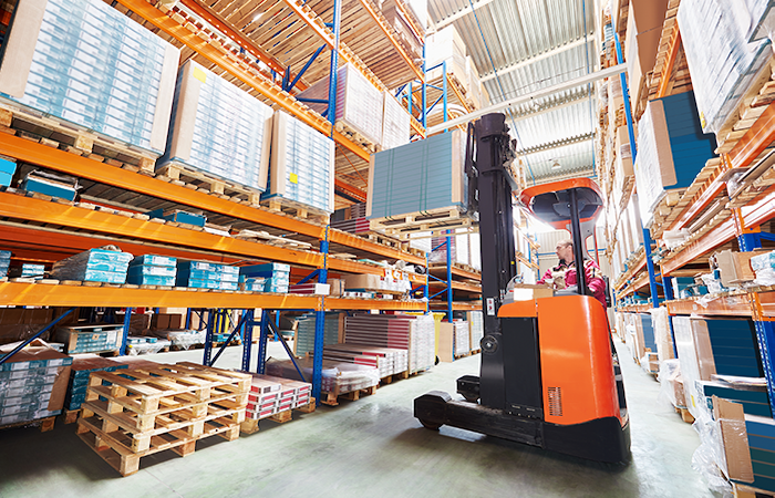 Impinj employee operating a forklift in an organized warehouse, reflecting efficient inventory management with Impinj technology