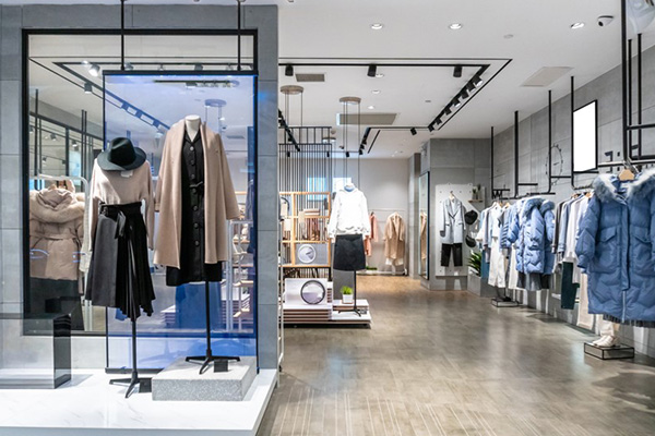 The image showcases a modern and stylish clothing retail store, featuring a clean and well