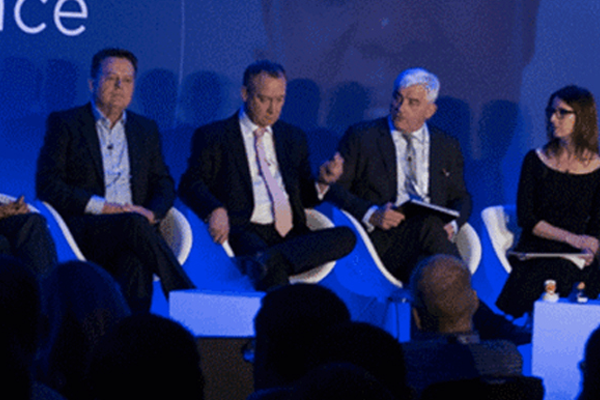 Panel of experts discussing technology advancements at an Impinj conference, engaging with the