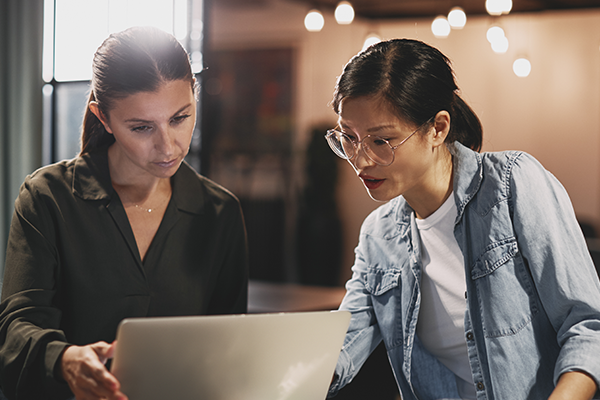 Photo of women collaborating with a laptop