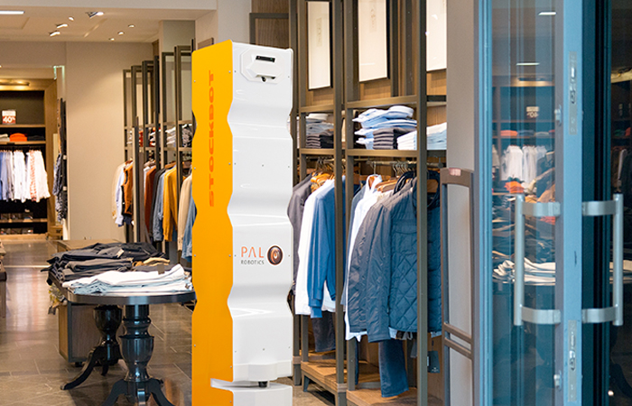 PAL Robotics retail service robot in a modern clothing store, reflecting Impinj's innovative technology for an enhanced shopping experience