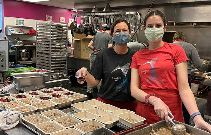 Two volunteers at Impinj are engaged in a community service event, preparing nutritious